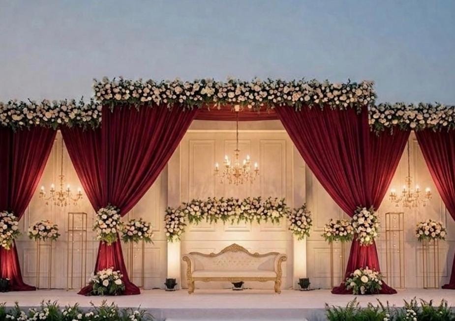Wedding planning and decoration by The Tenderful - floral mandap stage with red drapes in Delhi